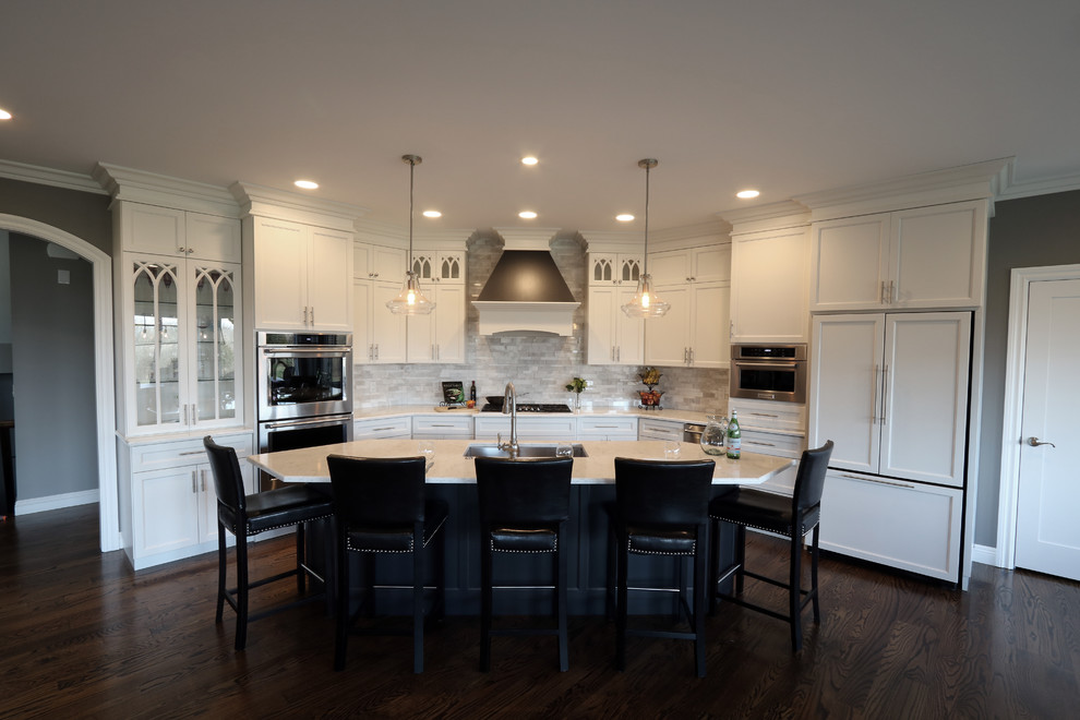Open concept kitchen - large transitional u-shaped dark wood floor open concept kitchen idea in Cincinnati with a single-bowl sink, flat-panel cabinets, white cabinets, granite countertops, gray backsplash, subway tile backsplash, paneled appliances and an island