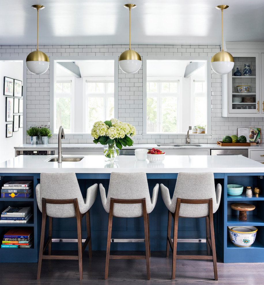 Large transitional l-shaped medium tone wood floor and brown floor eat-in kitchen photo in New York with a double-bowl sink, shaker cabinets, blue cabinets, quartz countertops, white backsplash, ceramic backsplash, stainless steel appliances and an island