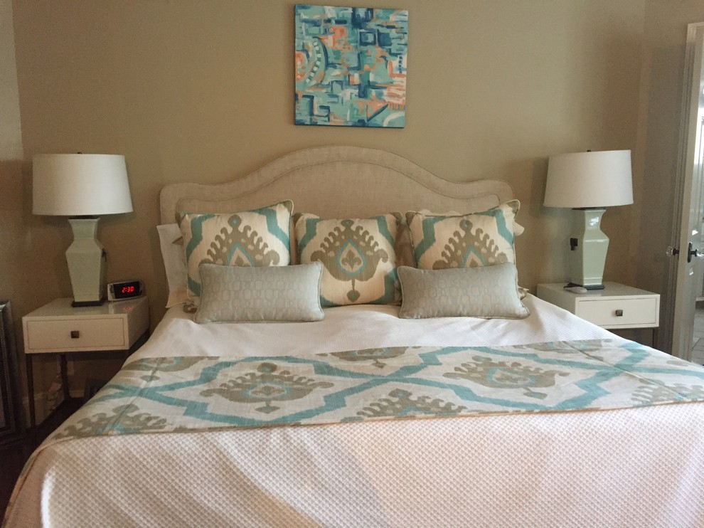 Example of a transitional master bedroom design with beige walls
