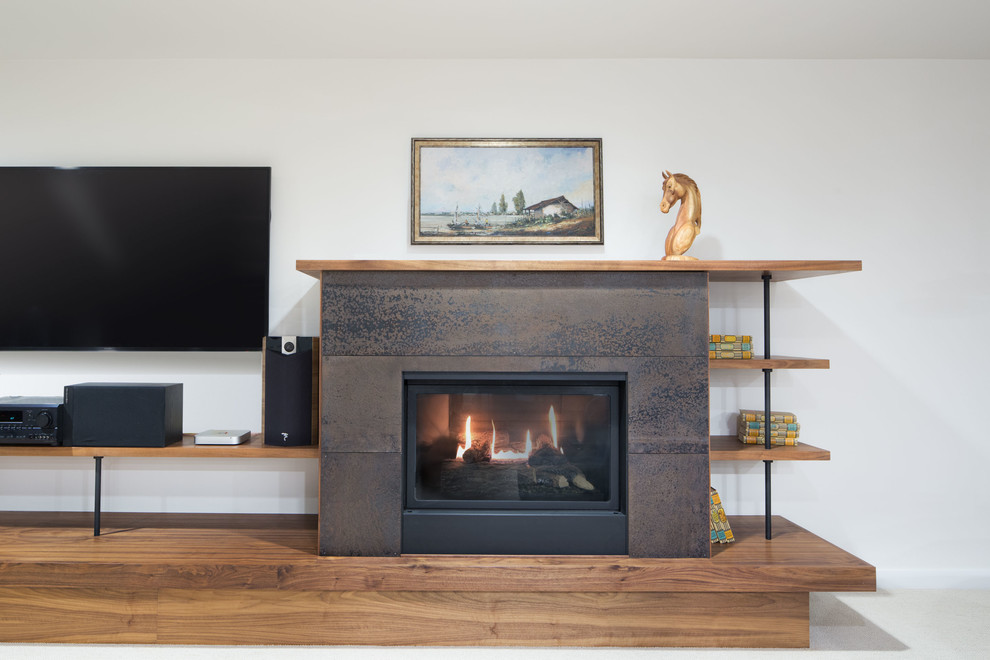 Photo of a mid-sized modern open concept family room in Seattle with white walls, carpet, a standard fireplace, a metal fireplace surround and a wall-mounted tv.