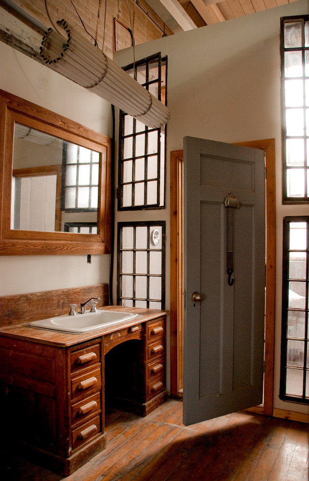 This is an example of a country bathroom in Toronto with wood benchtops.
