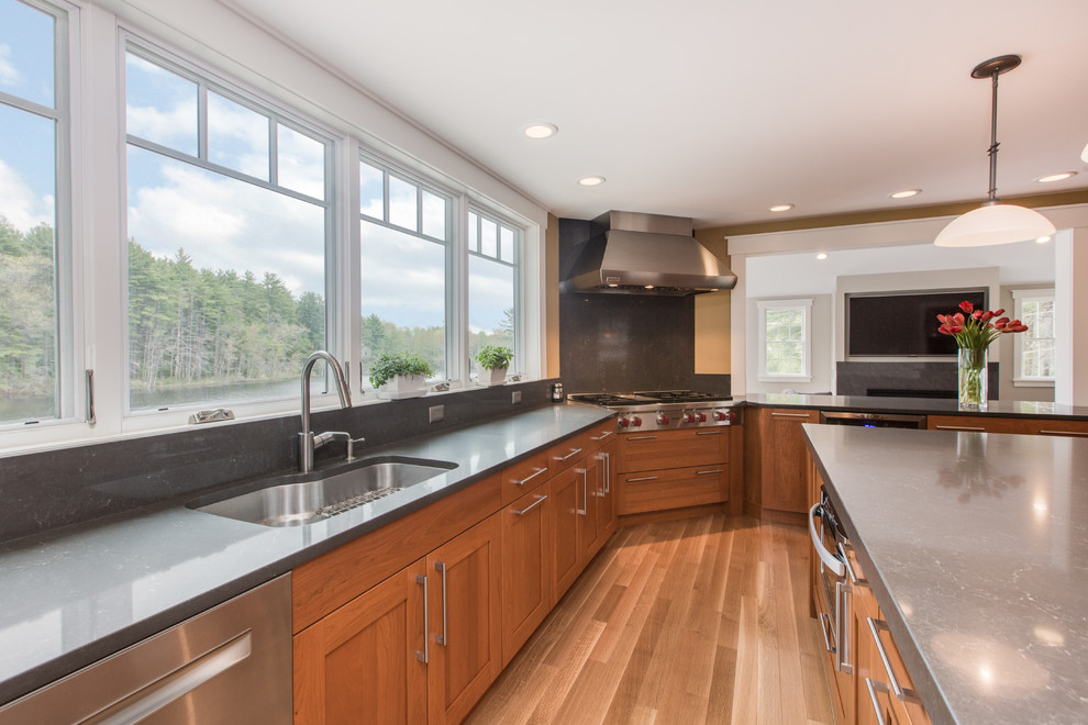 Kitchen - transitional u-shaped medium tone wood floor kitchen idea in Boston with an undermount sink, shaker cabinets, medium tone wood cabinets, quartz countertops, gray backsplash, stone slab backsplash, stainless steel appliances and an island