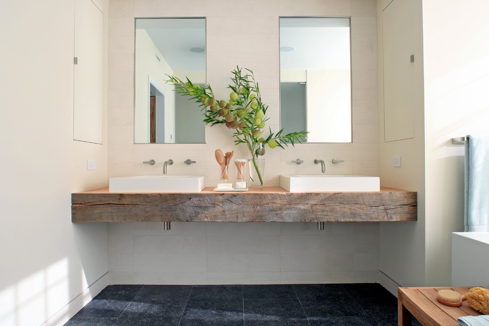 Photo of a mid-sized contemporary master bathroom in Chicago with a vessel sink, open cabinets, medium wood cabinets, white tile, porcelain tile, white walls, porcelain floors, wood benchtops, black floor and brown benchtops.
