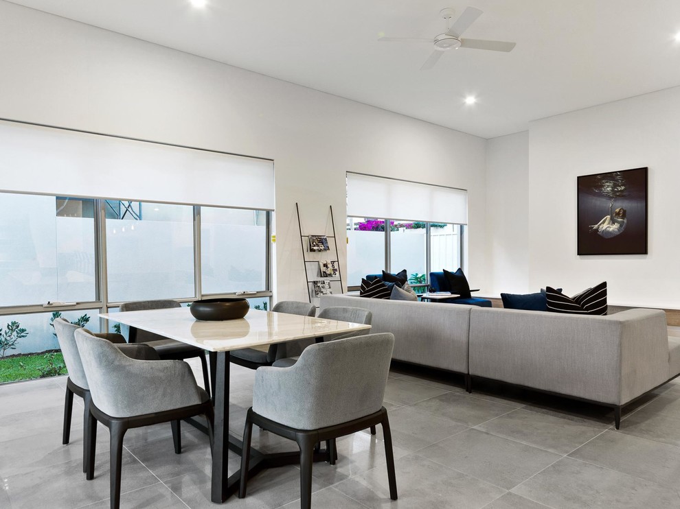 Large contemporary open plan dining in Perth with white walls, ceramic floors, no fireplace and grey floor.