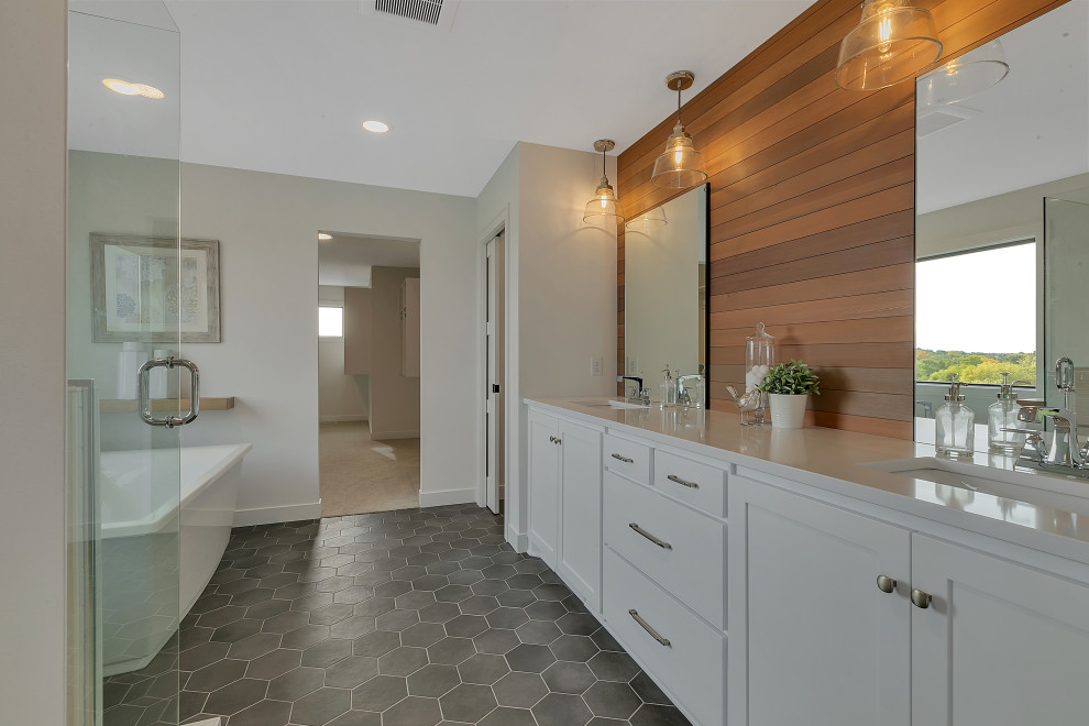 This is an example of a large farmhouse ensuite bathroom in Minneapolis with white cabinets, a freestanding bath, a corner shower, white tiles, a submerged sink, wooden worktops, grey floors, a hinged door, white worktops, an enclosed toilet, a single sink and a built in vanity unit.
