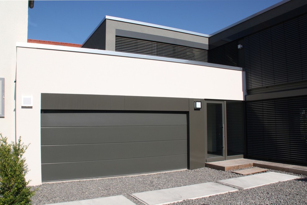 This is an example of a large contemporary attached two-car garage in Other.