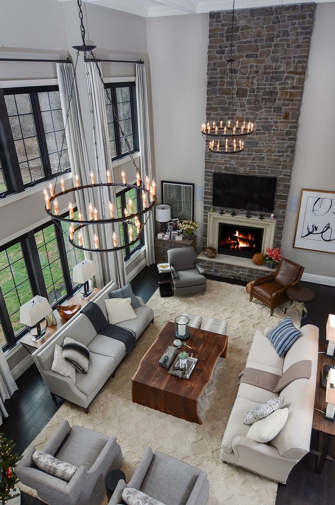 Example of a large trendy open concept dark wood floor family room design in Baltimore with gray walls, a standard fireplace, a stone fireplace and a wall-mounted tv