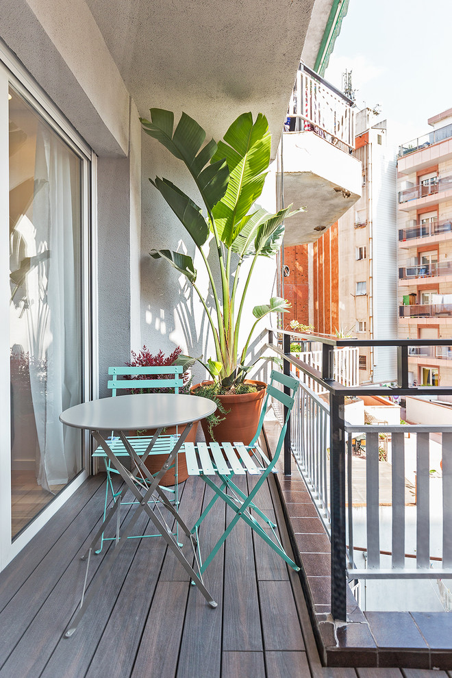 Mid-sized transitional balcony in Barcelona with a roof extension and metal railing for for apartments.