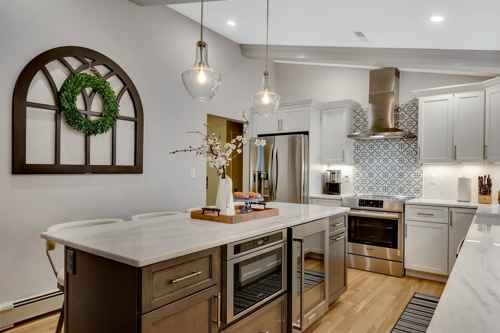 Example of a transitional light wood floor eat-in kitchen design in Boston with an island