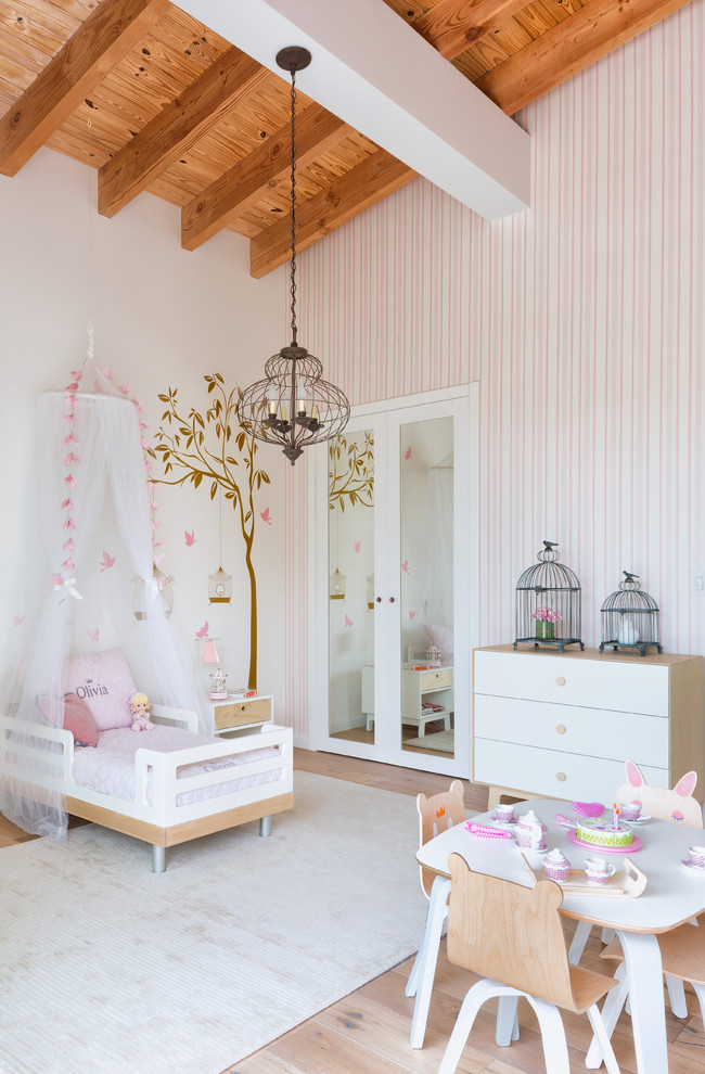 Bedroom and mid-sized beach style girl light wood floor kids' bedroom photo in Miami with pink walls
