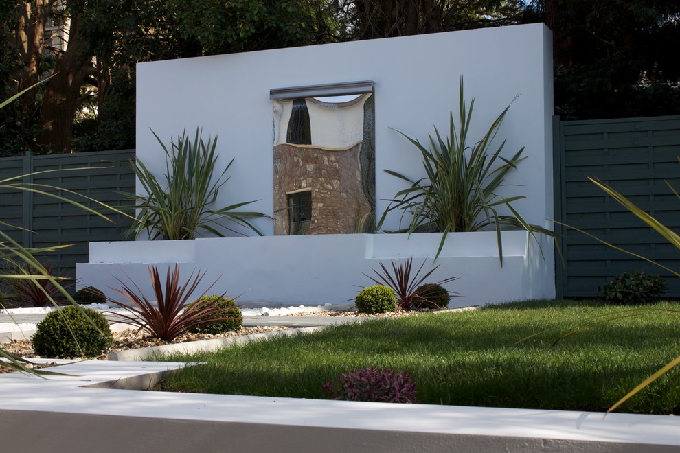 Photo of a large modern garden in Other with a water feature.