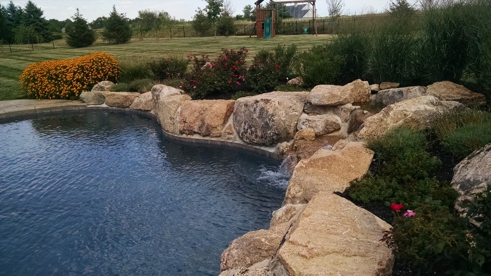 Mountain style backyard custom-shaped pool photo in New York