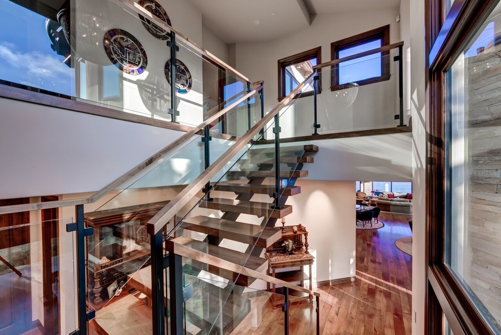 Photo of a mid-sized wood floating staircase in Orange County with open risers.
