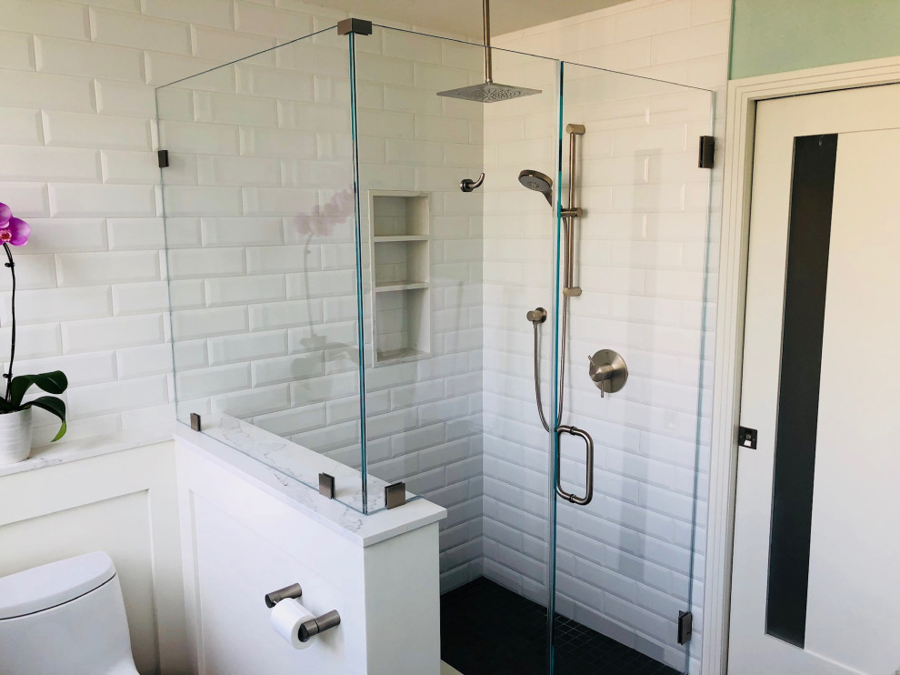 Small contemporary ensuite bathroom in Los Angeles with white cabinets, a built-in shower, a one-piece toilet, white tiles, ceramic tiles, blue walls, ceramic flooring, marble worktops, grey floors, a hinged door, white worktops, a shower bench, double sinks and wainscoting.