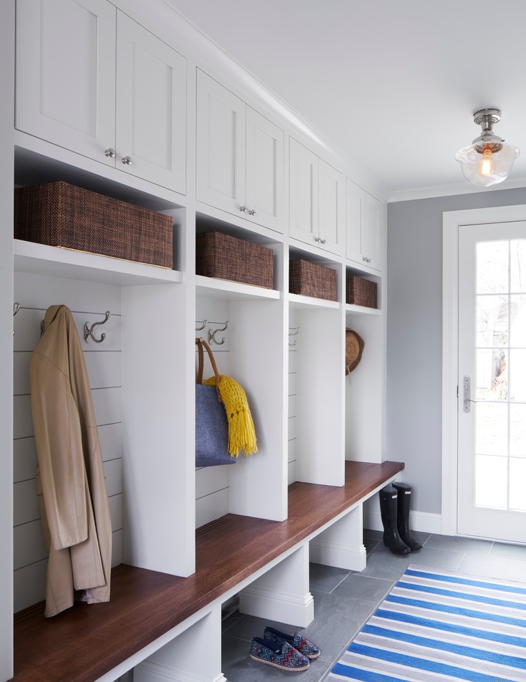 This is an example of a mid-sized transitional mudroom in Minneapolis with grey walls, vinyl floors, a single front door and a white front door.