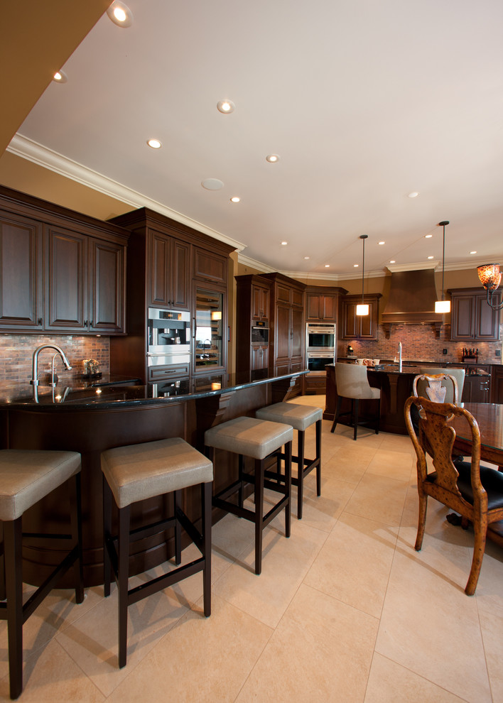 Inspiration for a huge rustic u-shaped porcelain tile and beige floor open concept kitchen remodel with an undermount sink, raised-panel cabinets, dark wood cabinets, granite countertops, red backsplash, porcelain backsplash, stainless steel appliances and a peninsula