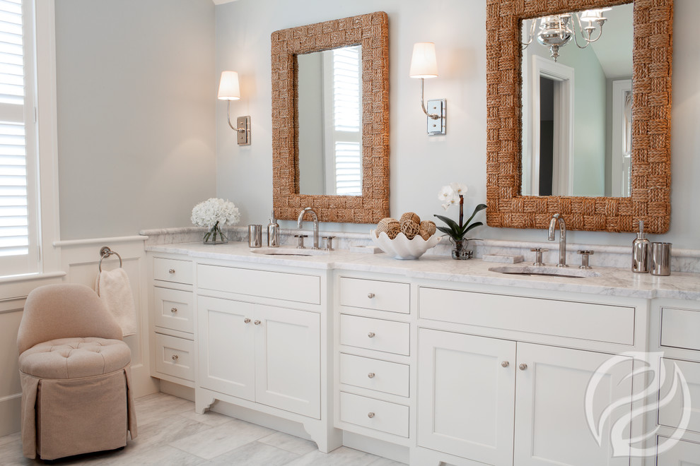 Inspiration for a large beach style master bathroom in Chicago with a wall-mount sink, beaded inset cabinets, white cabinets, marble benchtops, white tile, stone slab, blue walls and marble floors.
