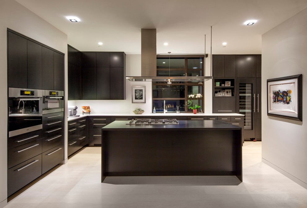 Design ideas for a contemporary l-shaped kitchen in Santa Barbara with flat-panel cabinets, dark wood cabinets, stainless steel appliances and with island.