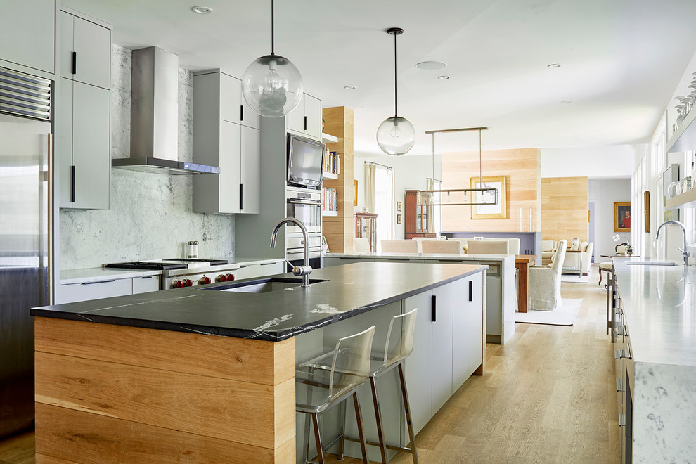 This is an example of a large modern l-shaped eat-in kitchen in Richmond with an undermount sink, flat-panel cabinets, white cabinets, marble benchtops, grey splashback, marble splashback, stainless steel appliances, medium hardwood floors, with island and beige floor.