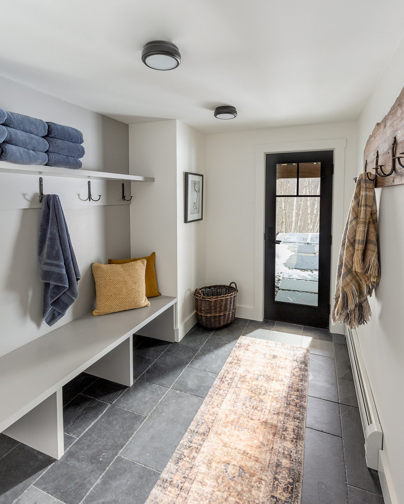 Photo of a medium sized traditional boot room in Burlington with white walls, porcelain flooring, a single front door, a black front door and grey floors.