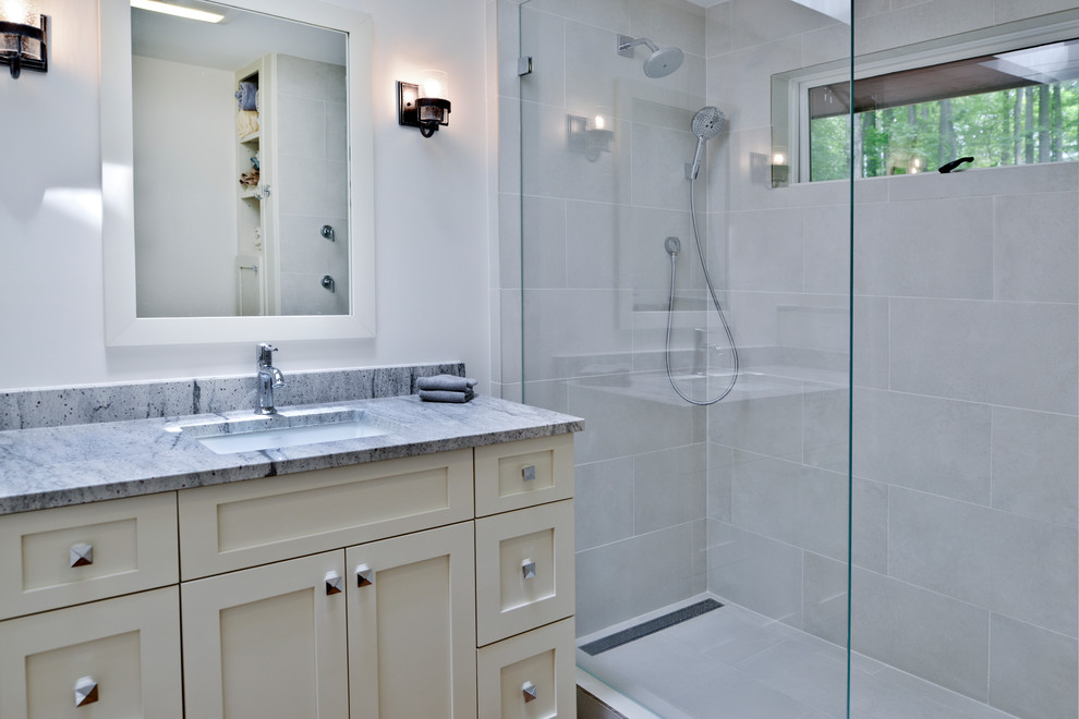 This is an example of a small traditional master bathroom in DC Metro with shaker cabinets, white cabinets, an open shower, a one-piece toilet, gray tile, porcelain tile, grey walls, light hardwood floors, an undermount sink, granite benchtops, brown floor, an open shower and grey benchtops.