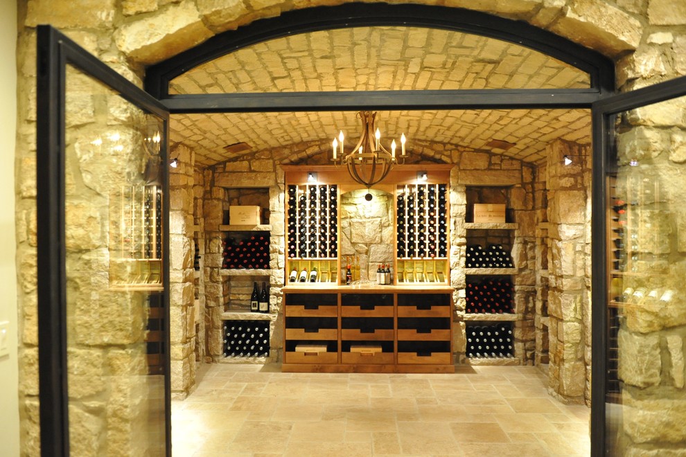 Photo of a large midcentury wine cellar in Los Angeles with terra-cotta floors and display racks.