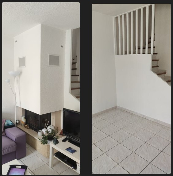 Offenes Wohnzimmer mit weißer Wandfarbe, Eckkamin und grauem Boden in Montpellier