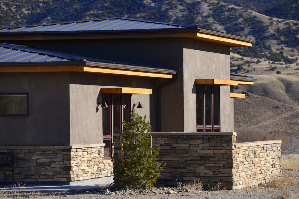 Photo of a contemporary one-storey brown exterior in Denver with stone veneer.