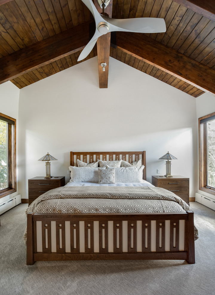 Mid-sized country guest bedroom in Salt Lake City with white walls, carpet, beige floor and no fireplace.