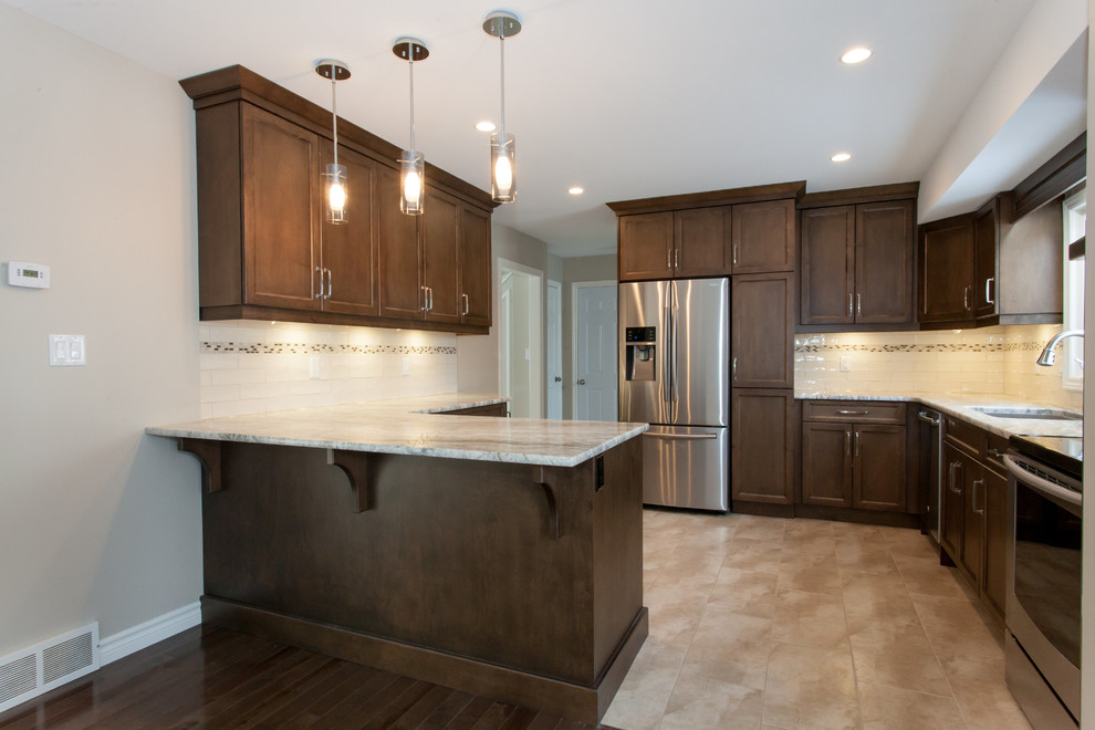 Eat-in kitchen - mid-sized transitional u-shaped porcelain tile eat-in kitchen idea in Toronto with an undermount sink, recessed-panel cabinets, dark wood cabinets, granite countertops, white backsplash, porcelain backsplash, stainless steel appliances and a peninsula