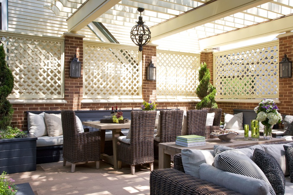 This is an example of a large traditional patio in Chicago with a pergola.