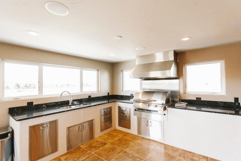 Example of a transitional slate floor kitchen design with a double-bowl sink, granite countertops, stainless steel appliances and beige walls