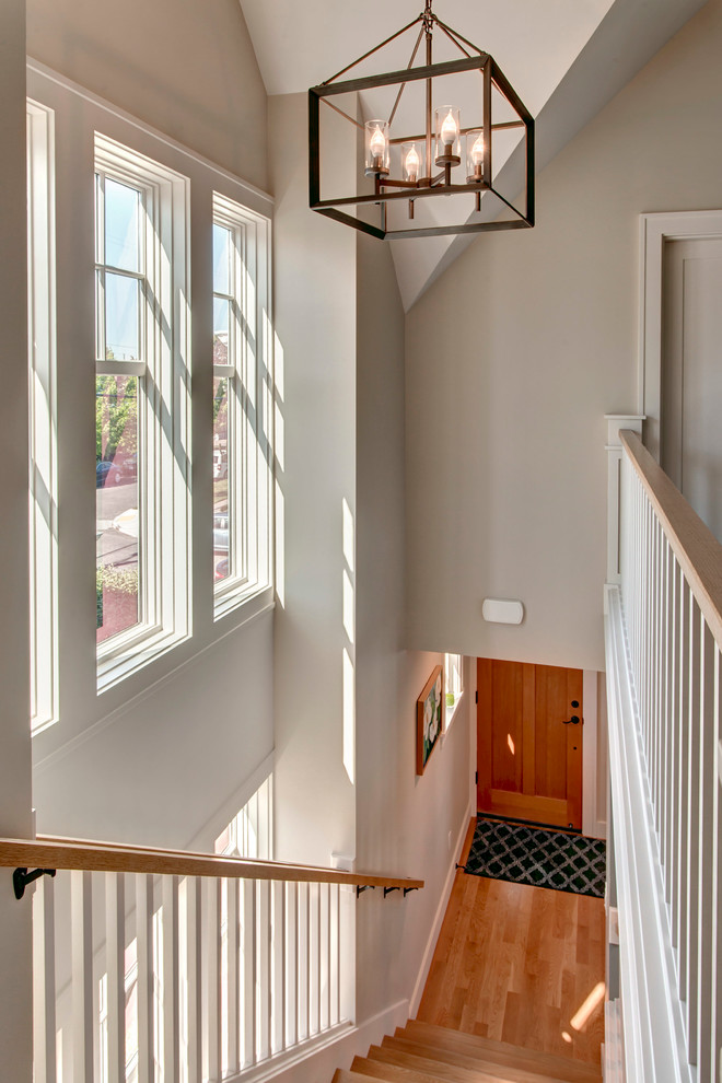 Inspiration for a traditional wood straight staircase in Seattle with painted wood risers.