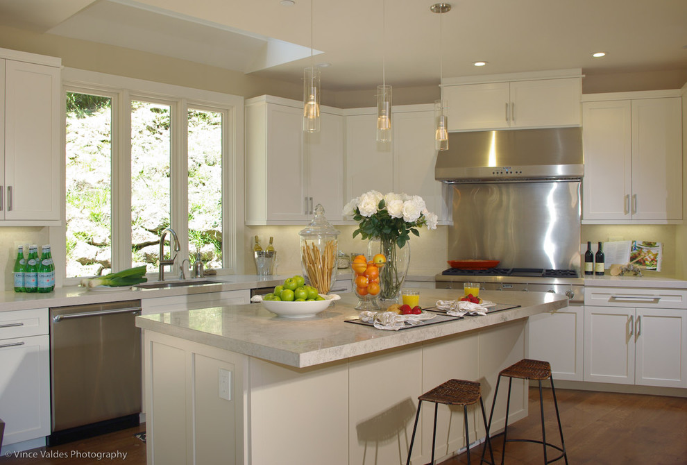 Beach style kitchen in San Francisco with stainless steel appliances and limestone benchtops.