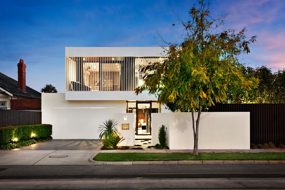 This is an example of a mid-sized contemporary two-storey white exterior in Melbourne with a flat roof.