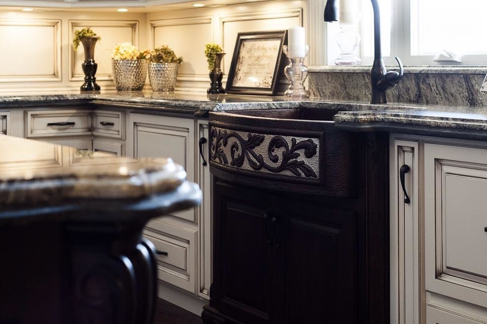 Example of a large transitional l-shaped dark wood floor and brown floor eat-in kitchen design in Birmingham with a farmhouse sink, raised-panel cabinets, white cabinets, brown backsplash, stainless steel appliances and an island