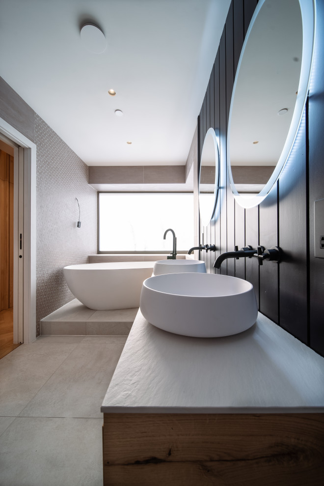 На фото: большая ванная комната в стиле модернизм с фасадами цвета дерева среднего тона, белой столешницей, тумбой под две раковины и подвесной тумбой