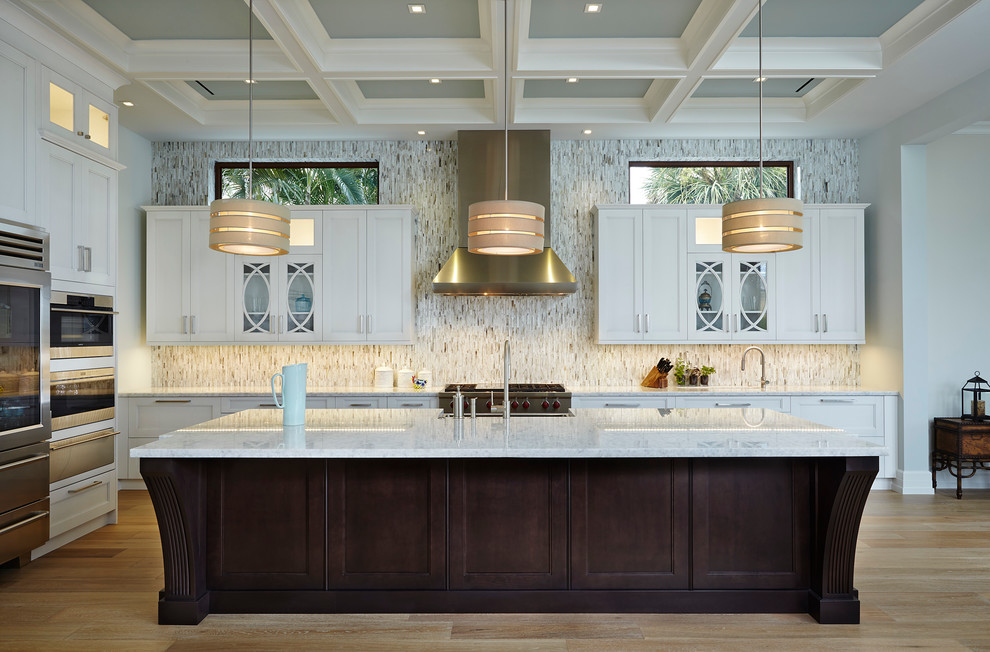 Inspiration for a large transitional l-shaped separate kitchen in Miami with shaker cabinets, white cabinets, multi-coloured splashback, stainless steel appliances, light hardwood floors, with island, an undermount sink, marble benchtops, matchstick tile splashback and brown floor.