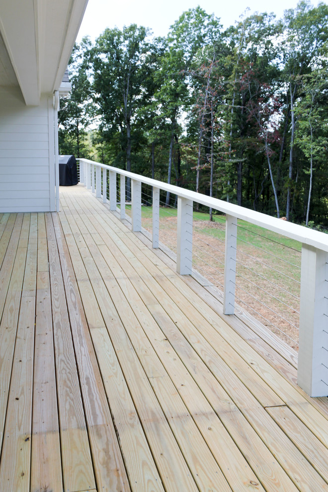 Photo of a mid-sized country backyard verandah in Other with decking and a roof extension.