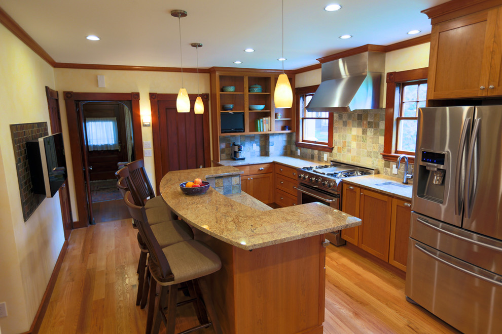 Transitional eat-in kitchen photo in Boston with an undermount sink, shaker cabinets, medium tone wood cabinets, granite countertops, multicolored backsplash, stone tile backsplash and stainless steel appliances