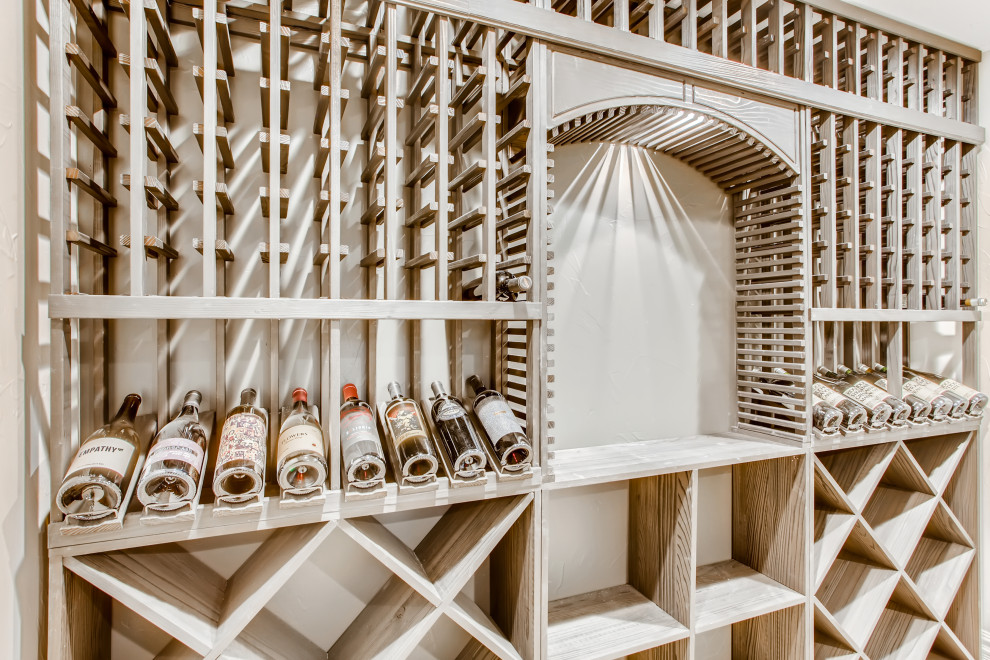 This is an example of a medium sized contemporary wine cellar in Denver with vinyl flooring, display racks and brown floors.