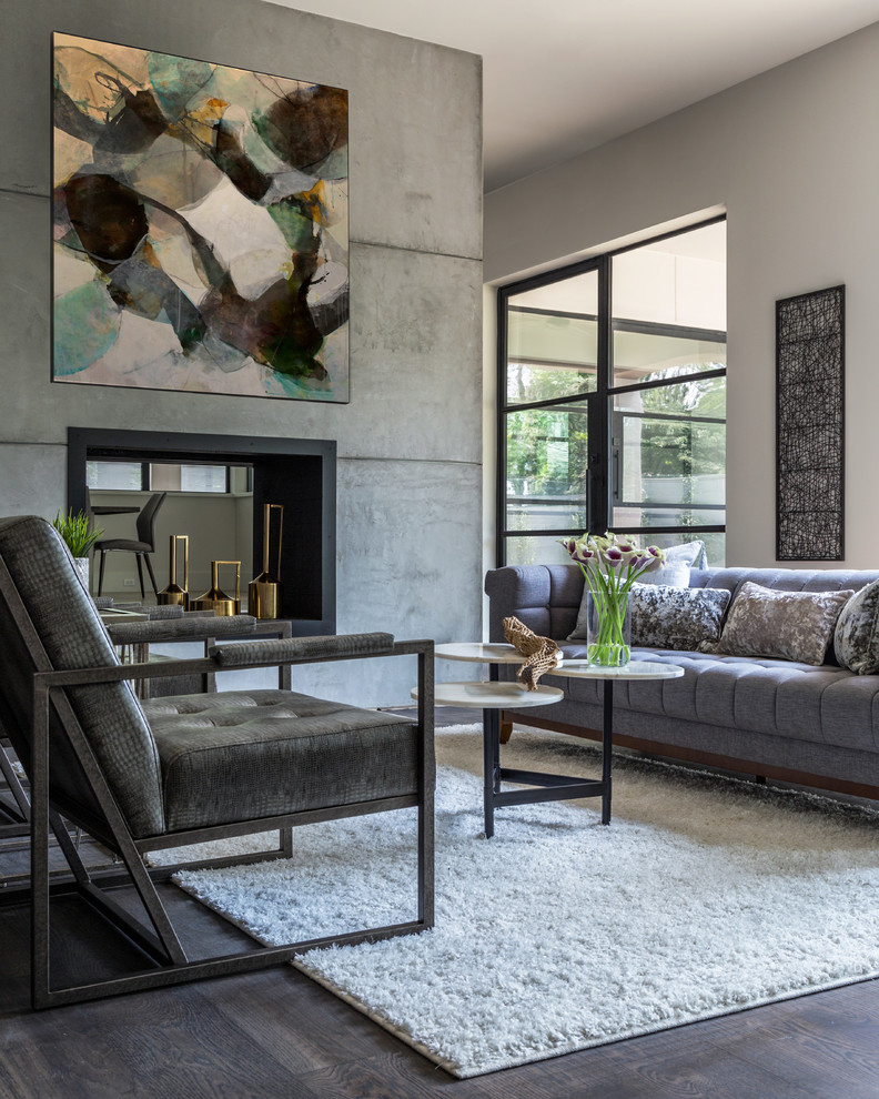 This is an example of a mid-sized transitional open concept family room in Houston with white walls, medium hardwood floors, a two-sided fireplace, a concrete fireplace surround and a wall-mounted tv.