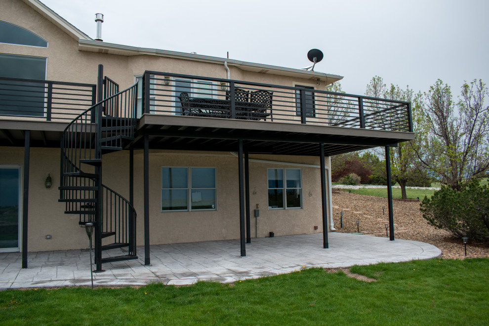 Idéer för en stor modern terrass på baksidan av huset, med räcke i metall