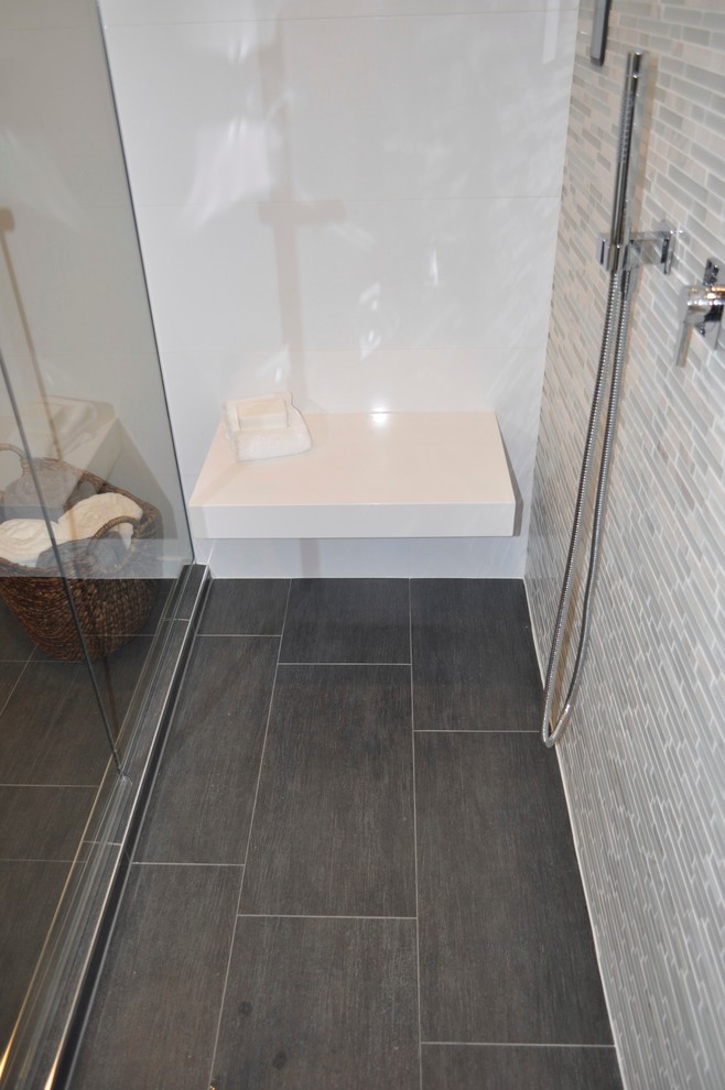 Design ideas for a mid-sized contemporary bathroom in Chicago with a vessel sink, flat-panel cabinets, medium wood cabinets, engineered quartz benchtops, a wall-mount toilet, gray tile, porcelain tile, beige walls, porcelain floors and with a sauna.