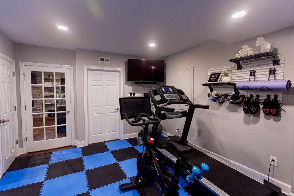 Mid-sized transitional multipurpose gym in Cincinnati with grey walls, travertine floors and multi-coloured floor.