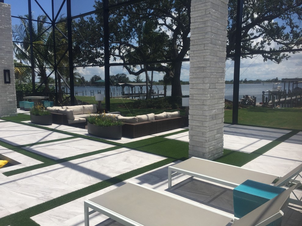 Photo of an expansive modern backyard custom-shaped natural pool in Orlando with decking.