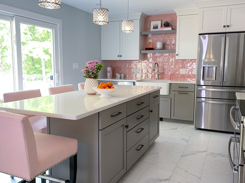 This is an example of a transitional eat-in kitchen in Boston with a farmhouse sink, shaker cabinets, white cabinets, quartz benchtops, pink splashback, ceramic splashback, stainless steel appliances, porcelain floors, with island, white floor and white benchtop.
