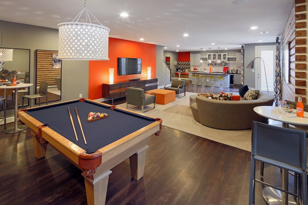 This is an example of a transitional walk-out basement in DC Metro with multi-coloured walls and dark hardwood floors.