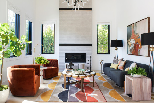 Cozy living room with fireplace, chairs, and rug. Follow colour tips for a harmonious decor scheme.
