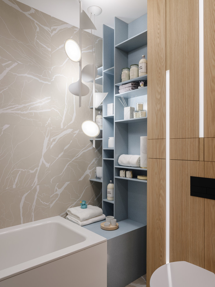 This is an example of a contemporary kids bathroom in Moscow with an alcove tub, beige tile, open cabinets, grey cabinets and stone slab.